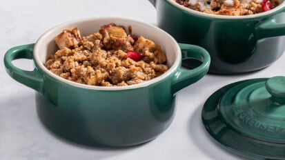 a close-up of a miniature le creuset cocotte filled with cobbler