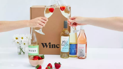 two hands clinking wine glasses together with winc wine box 