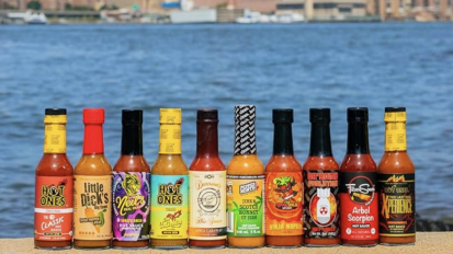 The hot sauce challenge lineup against a water front back drop