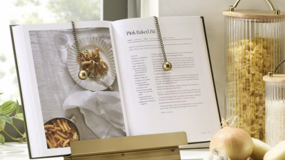 brass cookbook stand in a neutral tone kitchen