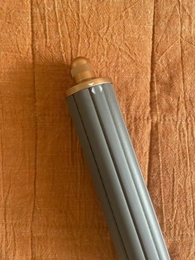 barrel of hair straightener on top of a blanket