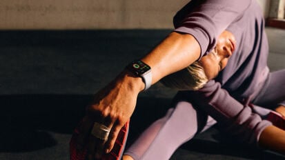 Person stretching wearing Apple Watch Series 10