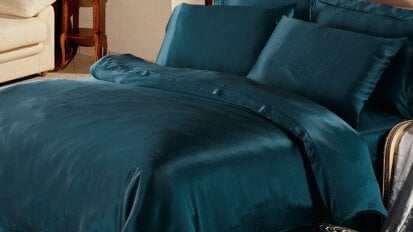 bed with turquoise silk sheets