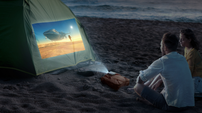 couple on beach with projector screen