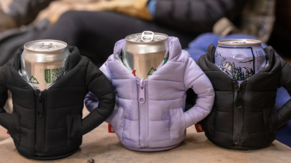 three cans wearing puffer jacket covers