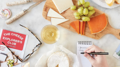 A person eating three different cheeses in front of them.