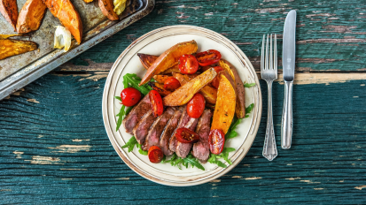 plate of steak, potatoes, and tomatoes 