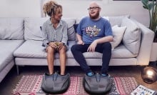 Two people using the MIKO Foot Massager on a couch.