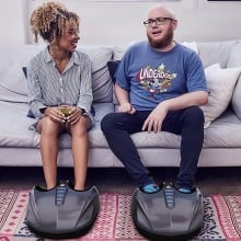 Two people using the MIKO Foot Massager on a couch.