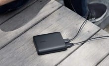 A black Anker Portable Charger on a table.