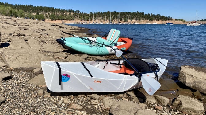 Two kayaks on a lake shore