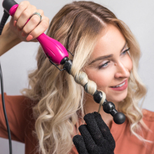 blonde woman curling her hair