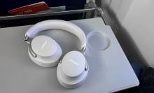 the bose quietcomfort ultra headphones on airplane tray table