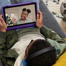 Children video calling on purple tablet