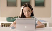 Child sitting in front of a laptop.