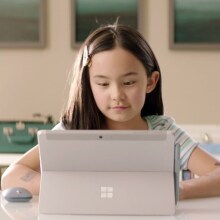 Child sitting in front of a laptop.