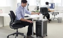 Person using the Fellowes Paper Shredder.