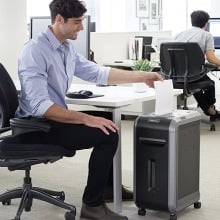 Person using the Fellowes Paper Shredder.