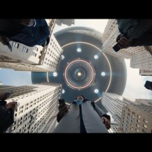 A flying saucer looms over New York skyscrapers.