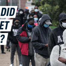 a line of people waiting to vote