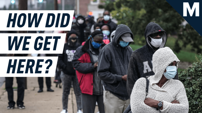 a line of people waiting to vote