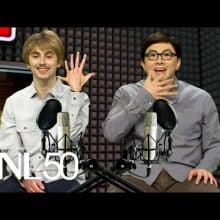 a white man with brown hair holding up a hand with six fingers. Next to him is an asian man in glasses wearing a button down shirt. Both are in a recording studio and surrounded by podcast equipment.