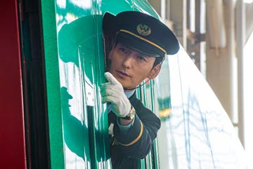 train conductor signaling from a train window in bullet train explosion