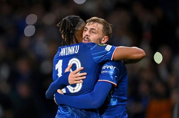 chelsea footballers kiernan dewsbury hall and christopher nkunku hug as they celebrate a goal