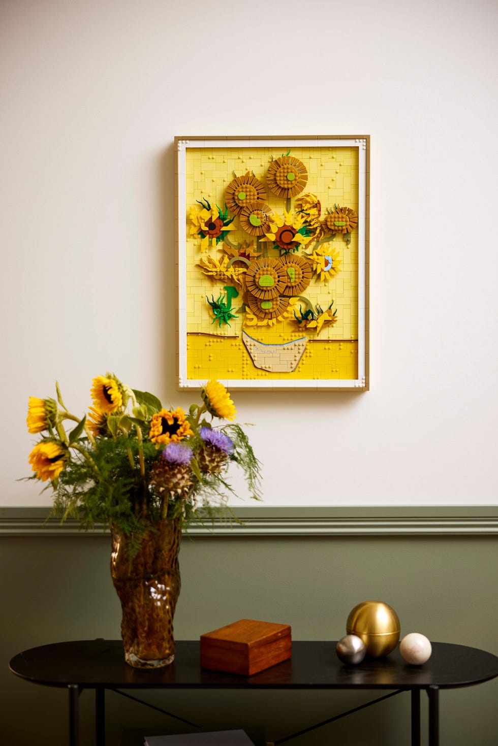 lego sunflowers painting hung next to some actual sunflowers