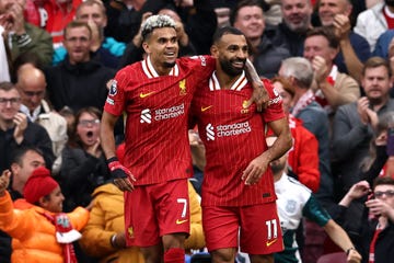 liverpool footballers luis diaz and mo salah hug each other and smile as they celebrate a goal