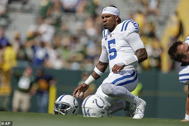 Anthony Richardson kneels during warm-ups before throwing three interceptions in Green Bay