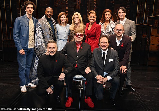 (Front left to right) David Furnish, Sir Elton John, Kevin McCollum and Jamie Wilson pose with Donatella Versace (Back C) and cast members (Back L-R) Rhys Whitfield, Matt Henry, Georgie Buckland, Vanessa Williams, Amy Di Bartolomeo and James Darch