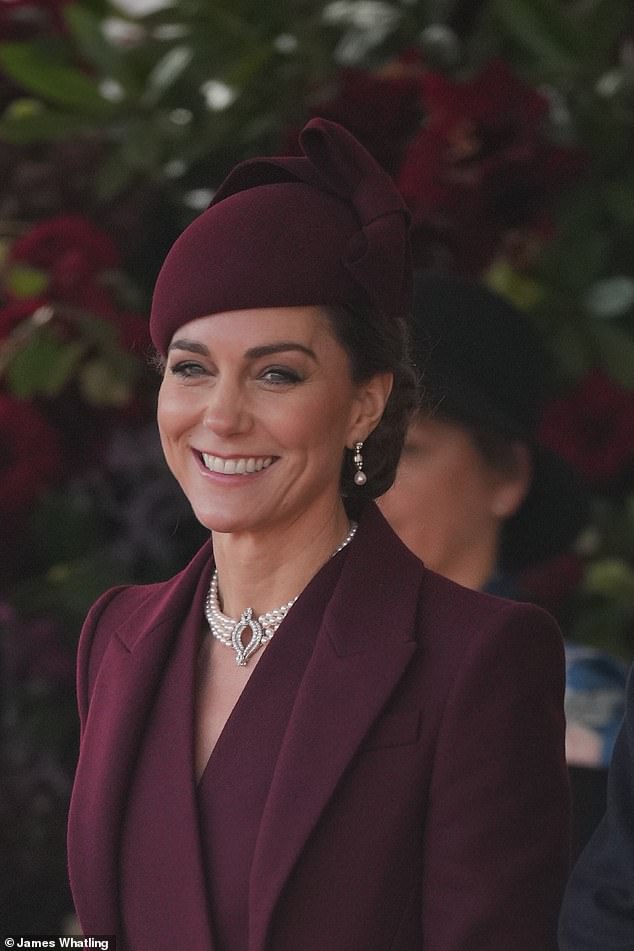 Kate looked radiant in a berry ensemble, comprising a chic coat dress by Sarah Burton for Alexander McQueen and a matching hat from Sahar Millinery