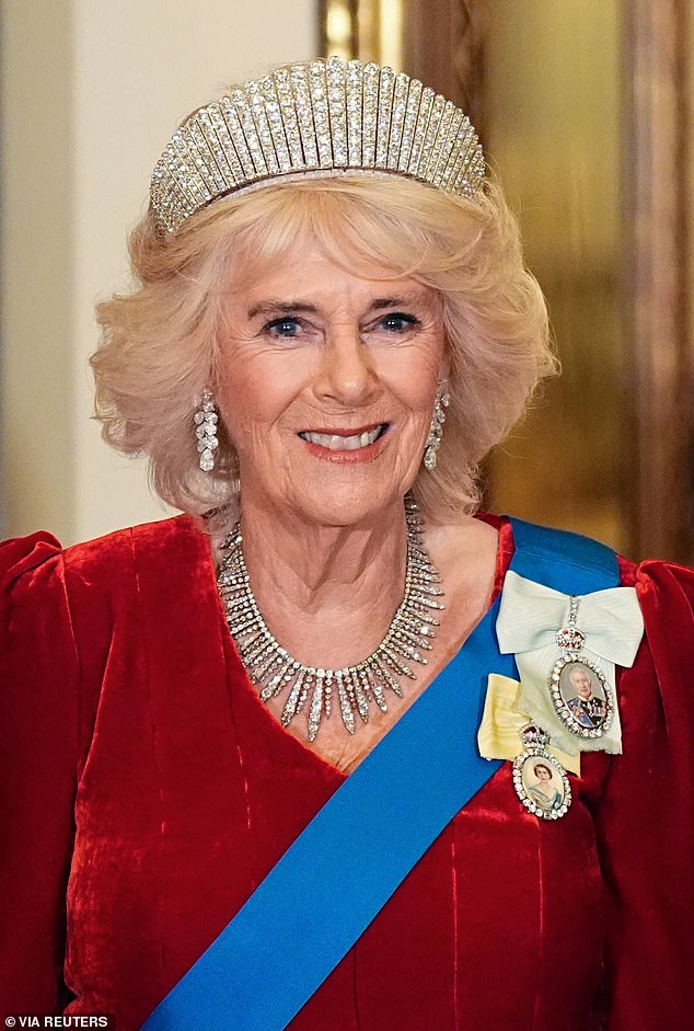 Queenm Camilla wore a red velvet dress by Fiona Clare