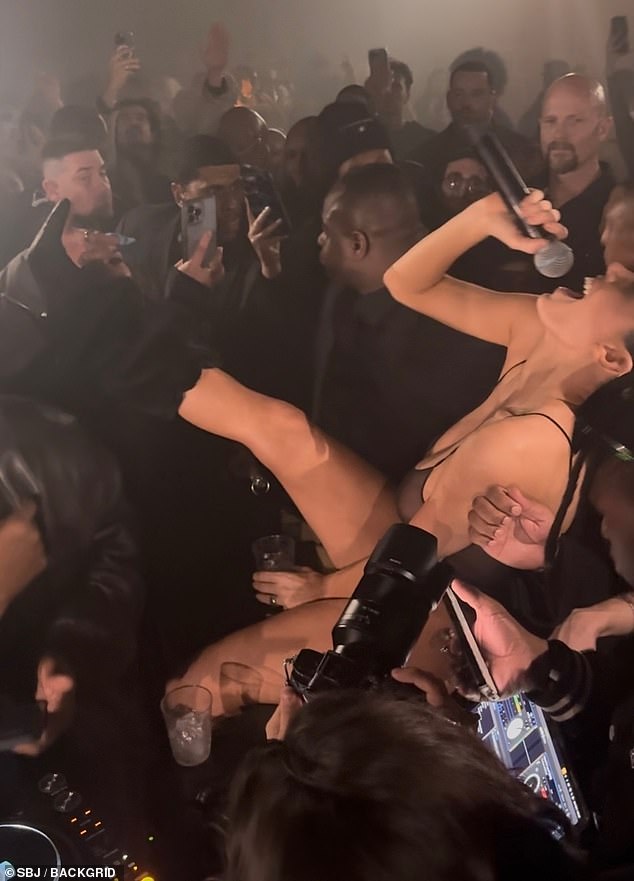 Kanye's wife was filmed putting on a naked performance at the Living Room Club as she belted the lyrics to Adele's Rolling In The Deep with the help of the crowd