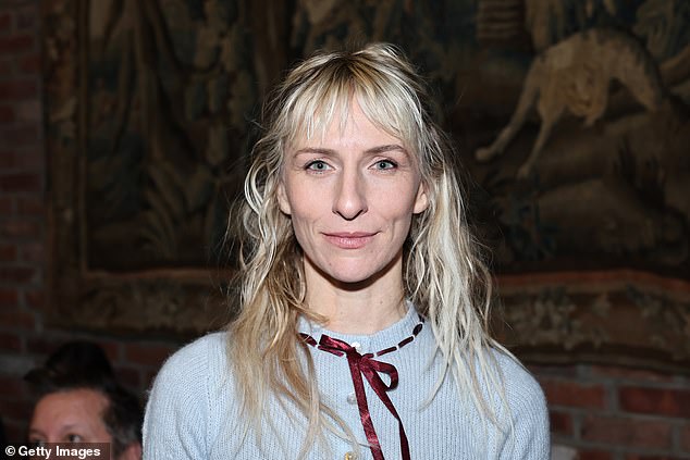 She added a burgundy ribbon around her collar and a selection of silver rings on each hand as she mingled with giants of the fashion world in the Big Apple