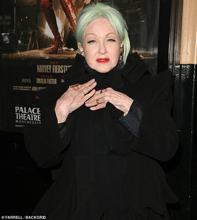 The singer, 71, commanded attention during the glitzy event at The Palace Theatre in a black belted coat and black maxi dress, adding a pair of black boots