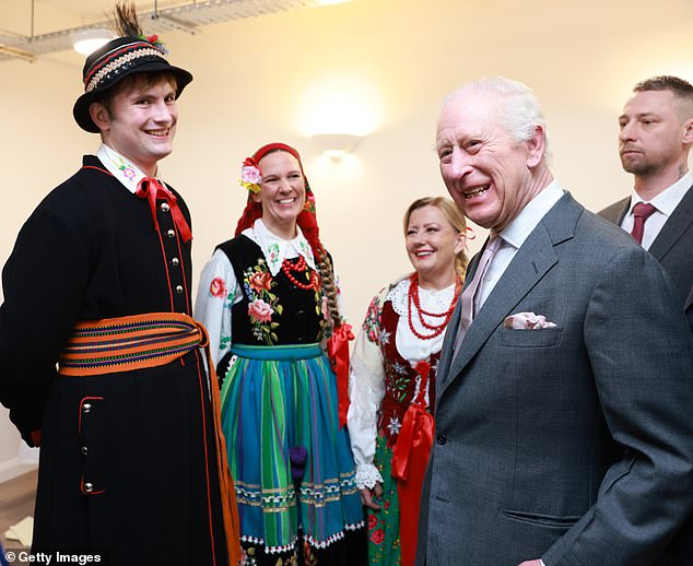 The father-of-two shared a laugh with members of the Polish community, who dressed in traditional attire