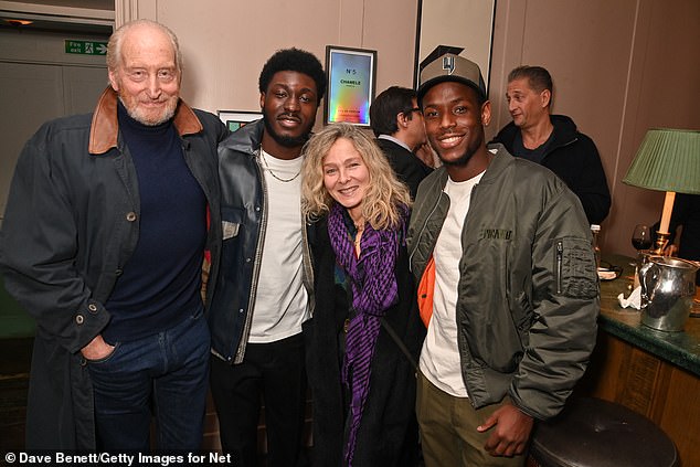 Charles (pictured, with Hope Ikpoku Jnr, centre-left, Alessandra, centre-right and Michael, right) added a pair of dark blue jeans and some brown Oxford shoes to complete the look