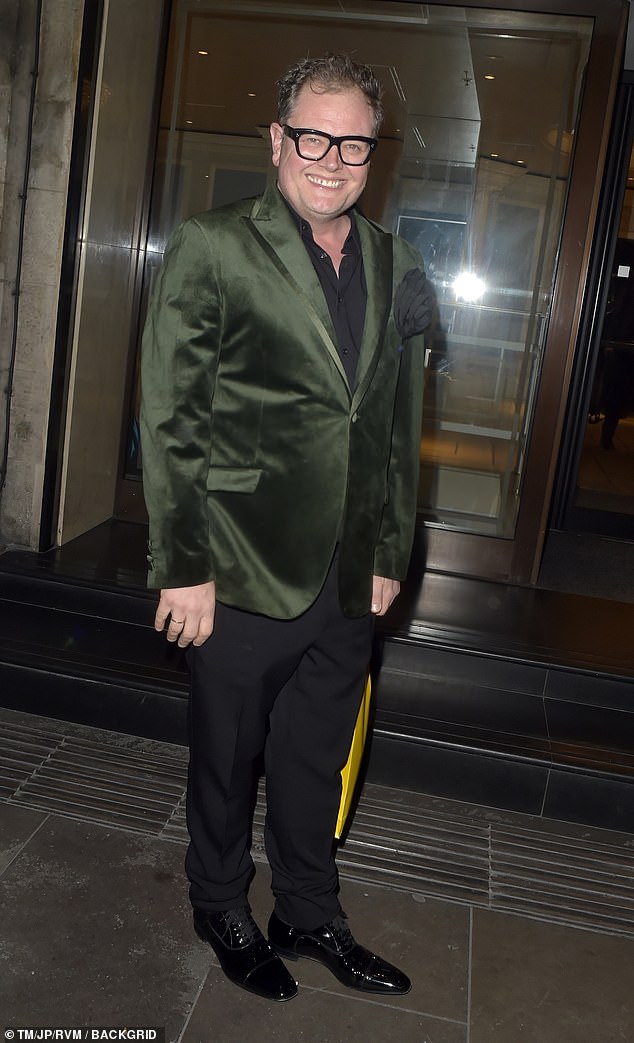 Alan Carr also cut a smart figure in a black suit, which he styled with a green satin jacket to add a pop of colour to his look