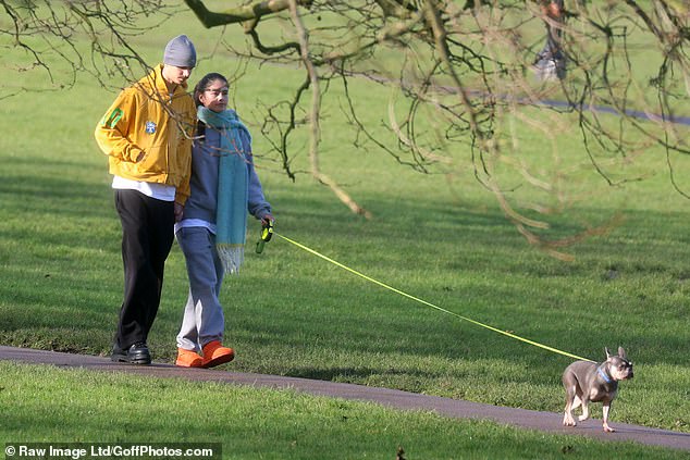 Kim, who is a DJ, wrapped up in a grey hoodie and tracksuit bottoms along with a thick teal scarf