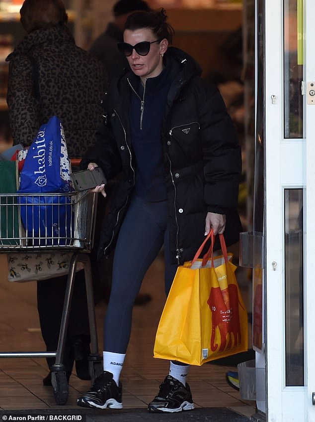 She added a pair of white socks and some black running shoes with a white sole as she carried an orange Bag For Life out of the supermarket