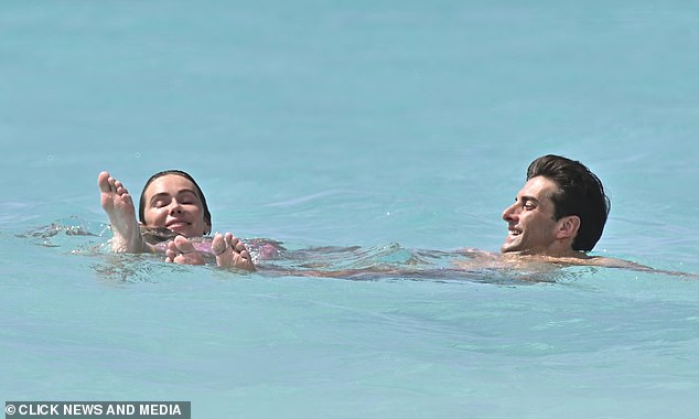 The happy couple blissfully floated together in the crystal clear waters