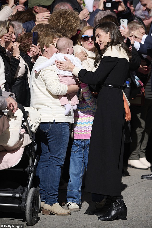 In a sweet exchange, the fashionable royal was seen talking to a mother and her child, placing one supportive hand on the baby's back