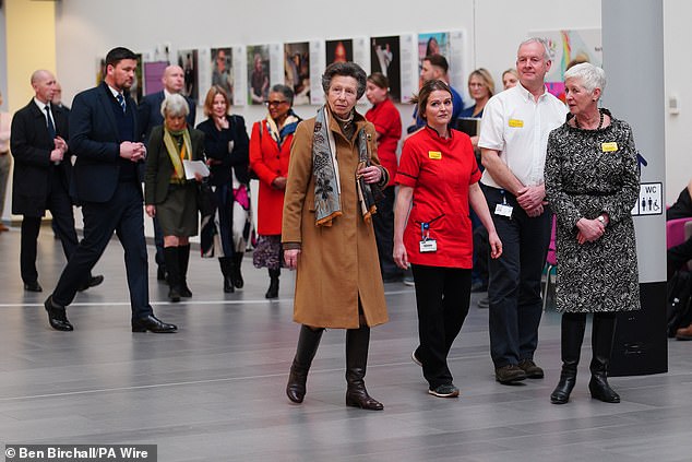 Dressed in a tan coat, which she accessorised with a brooch and patterned scarf, Anne looked typically elegant