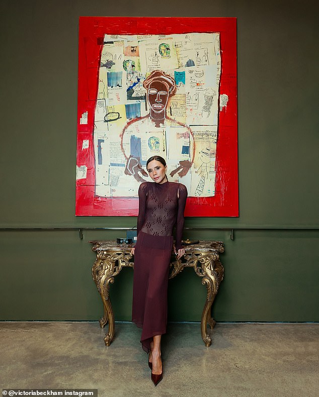 She added inches to her frame with a pair of burgundy pointed heels and styled her dark tresses in a sleek ponytail as she posed next to several contemporary paintings