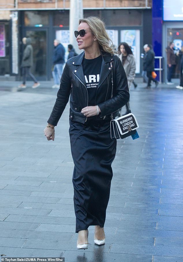 The radio and TV star, 53, wowed in a satin maxi skirt from Pretty Lavish, paired with a black Paris logo top from Mint Velvet