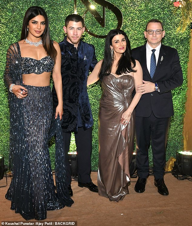 The couple posed alongside fellow guests ahead of the event in Mumbai in Thursday evening