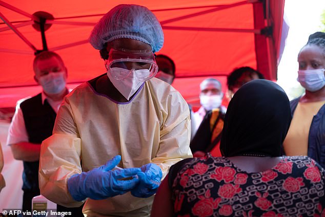 A nurse administers the first injection of the Ebola Sudan vaccine to a volunteer during the launch of an Ebola trial vaccination campaign at Mulago Referral Hospital in Kampala on February 3