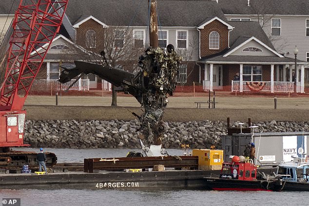 Salvage crews retrieved the mangled remains of the Army helicopter from the depths of the Potomac River on Thursday